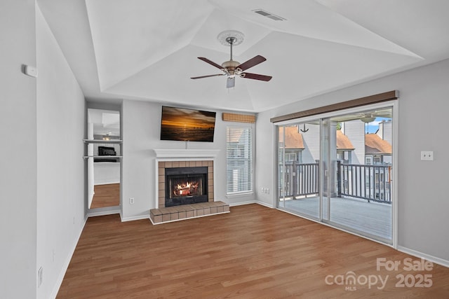 18853 Vineyard Point Ln, Cornelius, NC 28031 - unfurnished living room with a ceiling fan, wood finished floors, and a tray ceiling
