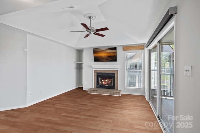 18853 Vineyard Point Ln, Cornelius, NC 28031 - unfurnished living room featuring light wood-type flooring, a ceiling fan, a fireplace, vaulted ceiling, and baseboards