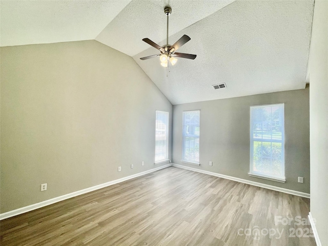 5800 Silver Eagle Dr, Charlotte, NC 28214 - empty room with vaulted ceiling, wood finished floors, a ceiling fan, plenty of natural light, and baseboards
