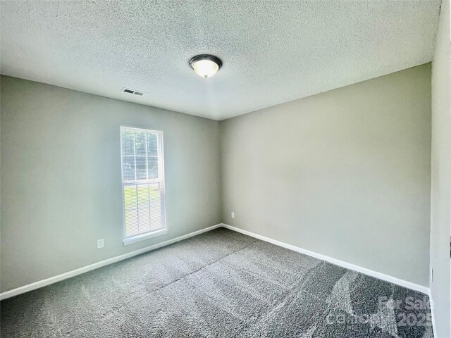 5800 Silver Eagle Dr, Charlotte, NC 28214 - unfurnished room featuring carpet, baseboards, and a textured ceiling