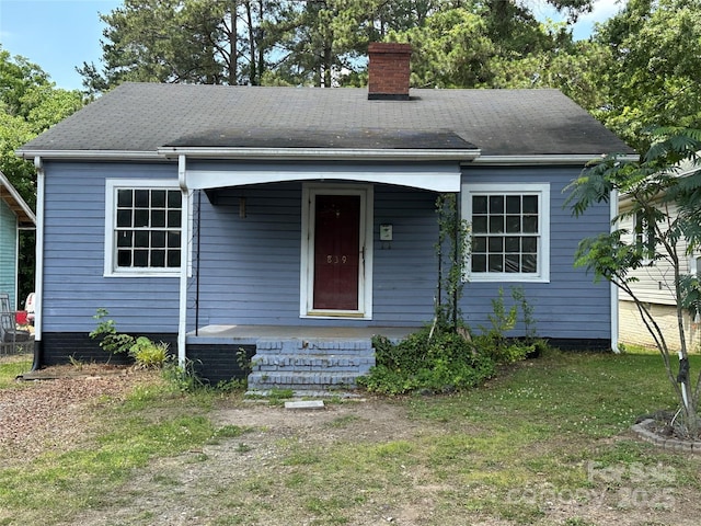 839 S Chester St, Gastonia, NC 28052 - view of front facade with a chimney, covered porch, a front yard, and roof with shingles