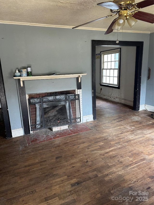 839 S Chester St, Gastonia, NC 28052 - unfurnished living room with wood finished floors, crown molding, a brick fireplace, a textured ceiling, and ceiling fan