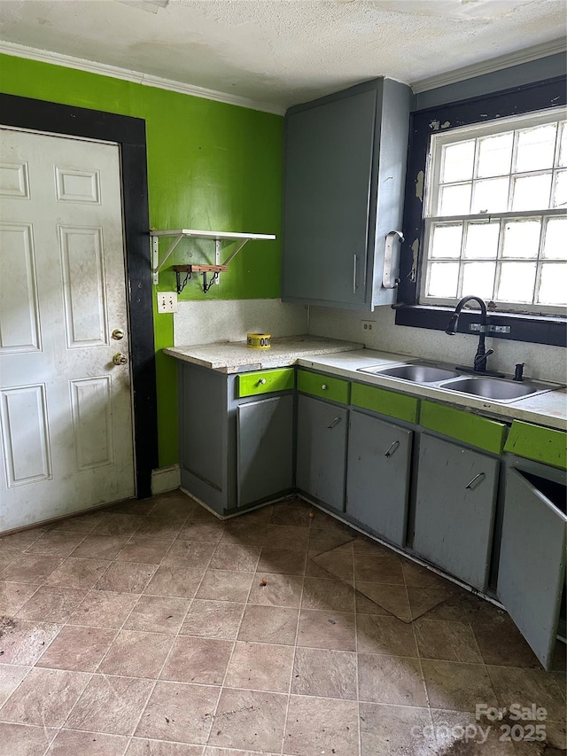 839 S Chester St, Gastonia, NC 28052 - kitchen featuring a sink, light countertops, ornamental molding, a textured ceiling, and light stone finish flooring