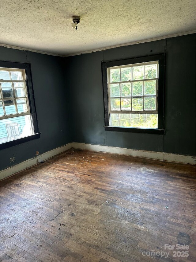 839 S Chester St, Gastonia, NC 28052 - spare room featuring hardwood / wood-style flooring, a textured ceiling, and baseboards
