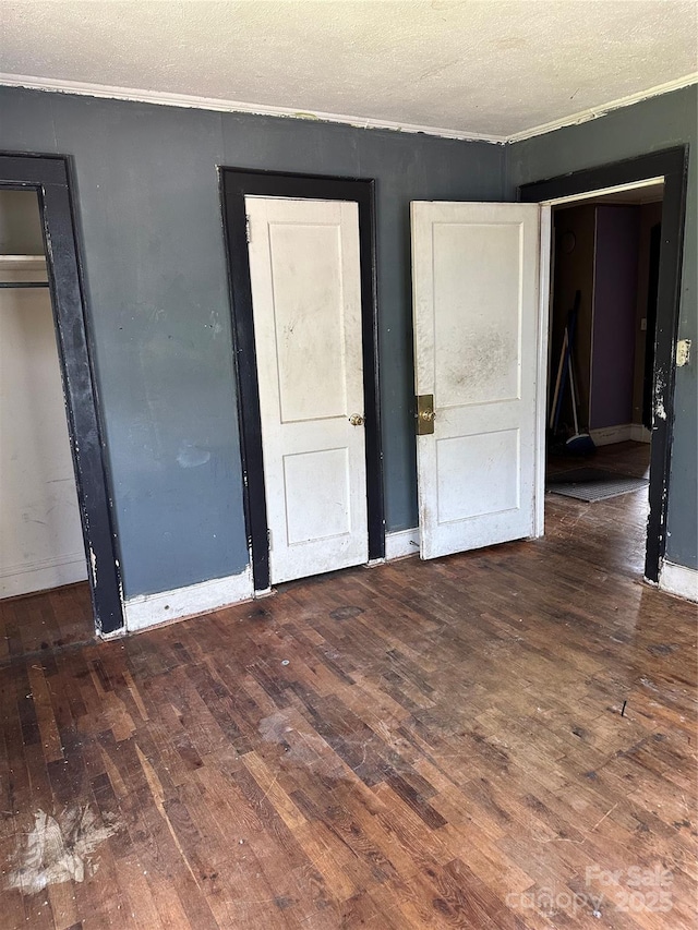 839 S Chester St, Gastonia, NC 28052 - unfurnished bedroom featuring wood-type flooring, crown molding, a textured ceiling, and baseboards