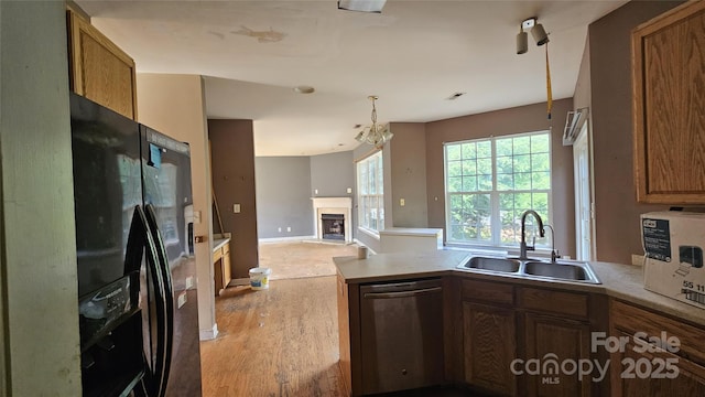 4227 Kiser Woods Dr SW, Concord, NC 28025 - kitchen featuring dishwasher, a sink, black fridge with ice dispenser, light wood-style flooring, and a peninsula