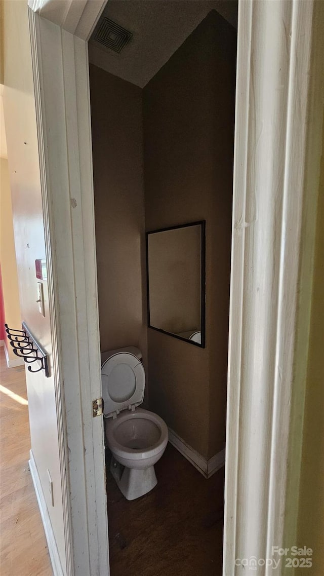 4227 Kiser Woods Dr SW, Concord, NC 28025 - bathroom featuring toilet, wood finished floors, and baseboards