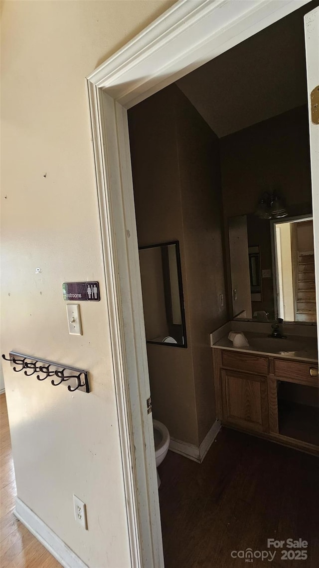 4227 Kiser Woods Dr SW, Concord, NC 28025 - bathroom with wood finished floors, vanity, toilet, and baseboards