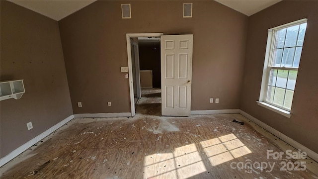 4227 Kiser Woods Dr SW, Concord, NC 28025 - empty room with vaulted ceiling and baseboards