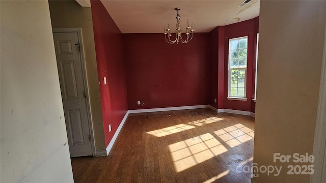 4227 Kiser Woods Dr SW, Concord, NC 28025 - spare room featuring wood finished floors, a chandelier, and baseboards