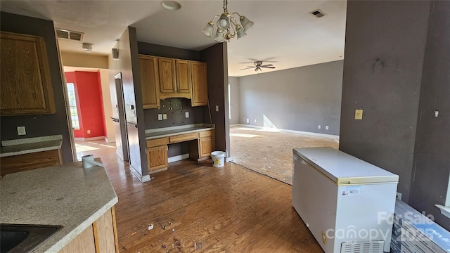4227 Kiser Woods Dr SW, Concord, NC 28025 - kitchen featuring a ceiling fan, baseboards, a chandelier, and dark wood-type flooring