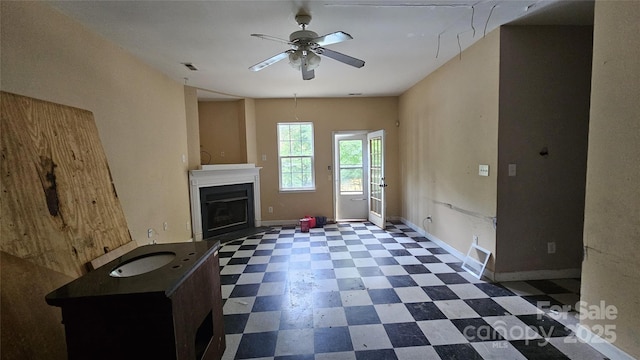 4227 Kiser Woods Dr SW, Concord, NC 28025 - unfurnished living room featuring tile patterned floors, a ceiling fan, baseboards, and a fireplace