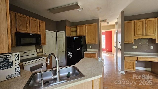 4227 Kiser Woods Dr SW, Concord, NC 28025 - kitchen featuring black appliances, a sink, open shelves, light countertops, and light wood-style flooring