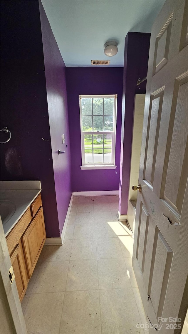 4227 Kiser Woods Dr SW, Concord, NC 28025 - full bath with baseboards, vanity, and shower / bathtub combination