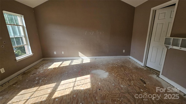 4227 Kiser Woods Dr SW, Concord, NC 28025 - spare room featuring lofted ceiling and baseboards