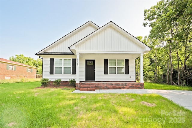 1028 Gibson St, Albemarle, NC 28001 - view of front of property featuring board and batten siding, a porch, and a front yard