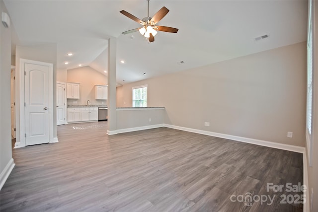 1028 Gibson St, Albemarle, NC 28001 - unfurnished living room featuring lofted ceiling, a sink, ceiling fan, wood finished floors, and baseboards