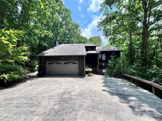 67 Cliffview Dr, Asheville, NC 28803 - view of front of property with asphalt driveway, a garage, and a chimney