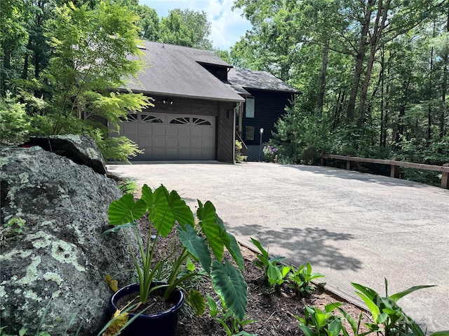 67 Cliffview Dr, Asheville, NC 28803 - view of front of home featuring an attached garage, driveway, and roof with shingles