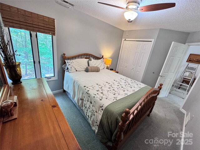 67 Cliffview Dr, Asheville, NC 28803 - carpeted bedroom with a textured ceiling, a closet, ceiling fan, and baseboards