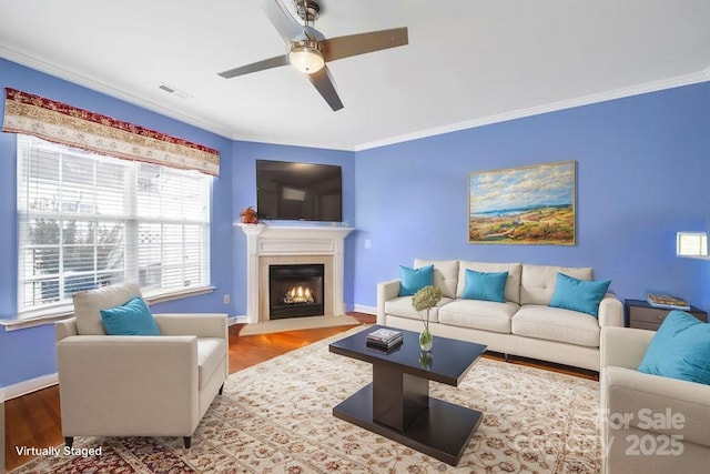 635 Brickdust Ct, Fort Mill, SC 29708 - living room with ceiling fan, ornamental molding, wood finished floors, and a fireplace with flush hearth