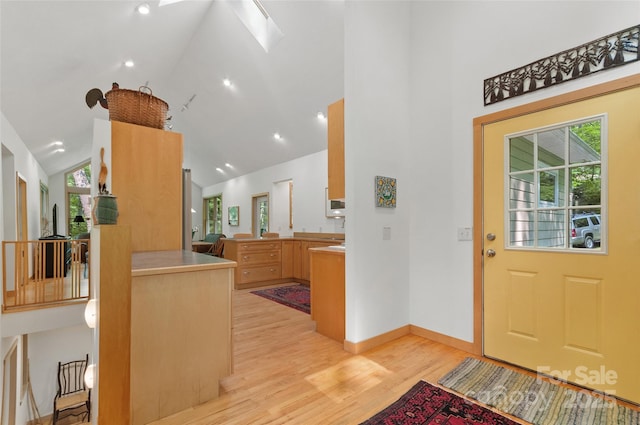 608 Brandywine Rd, Waynesville, NC 28786 - foyer with a skylight, high vaulted ceiling, plenty of natural light, light wood-type flooring, and baseboards