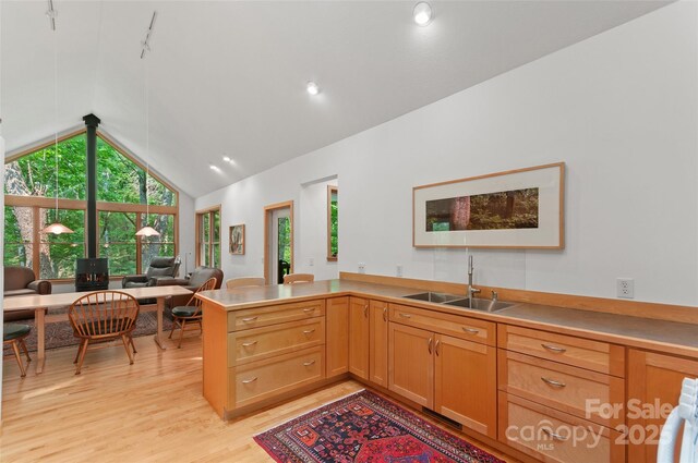 608 Brandywine Rd, Waynesville, NC 28786 - kitchen featuring a sink, light wood-style floors, a peninsula, light countertops, and high vaulted ceiling