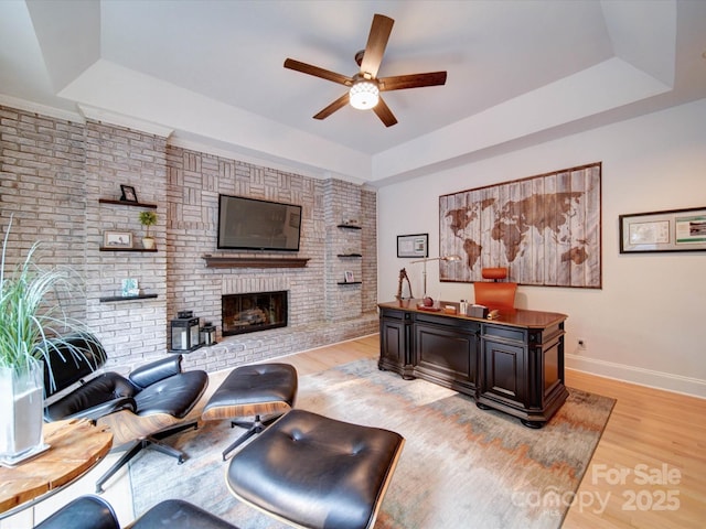 15708 Eagleview Dr, Charlotte, NC 28278 - living area with a tray ceiling, a ceiling fan, light wood-style flooring, baseboards, and a fireplace