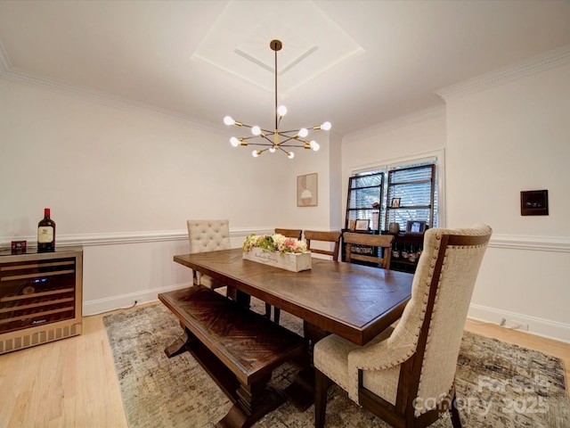 15708 Eagleview Dr, Charlotte, NC 28278 - dining area with beverage cooler, a chandelier, light wood-style flooring, ornamental molding, and baseboards