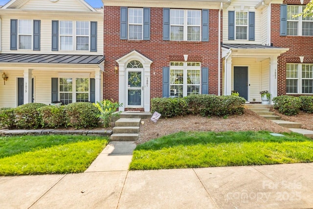 7881 Mariners Pointe Cir, Denver, NC 28037 - view of property with a standing seam roof, brick siding, and a metal roof