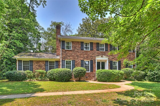 6434 Sardis Rd, Charlotte, NC 28270 - colonial inspired home featuring a chimney, a front yard, and brick siding