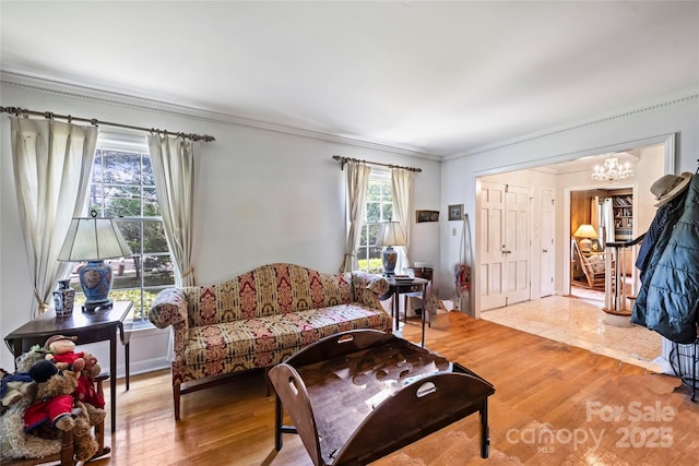 6434 Sardis Rd, Charlotte, NC 28270 - living area with a chandelier, ornamental molding, and light wood finished floors