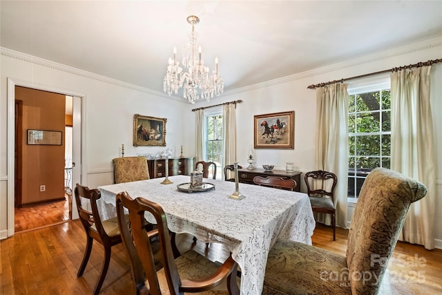 6434 Sardis Rd, Charlotte, NC 28270 - dining area with a chandelier, crown molding, and wood finished floors