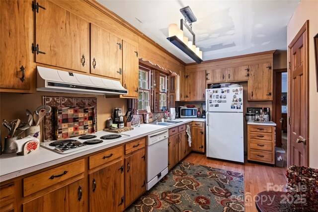6434 Sardis Rd, Charlotte, NC 28270 - kitchen with white appliances, under cabinet range hood, light countertops, and light wood finished floors