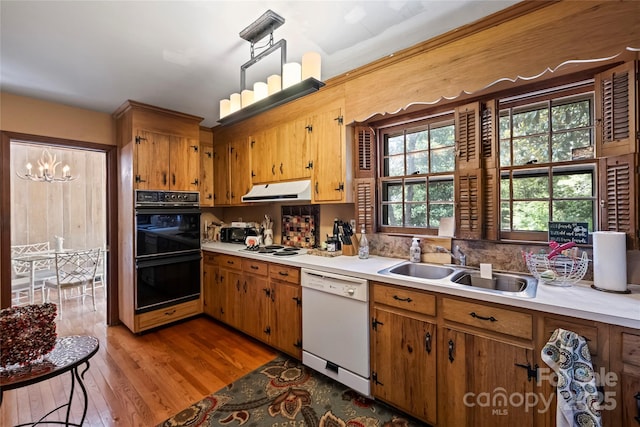 6434 Sardis Rd, Charlotte, NC 28270 - kitchen featuring white appliances, extractor fan, light countertops, a sink, and light wood-type flooring