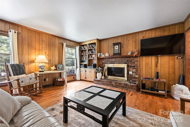 6434 Sardis Rd, Charlotte, NC 28270 - living area featuring wooden walls, a fireplace, and light wood-type flooring