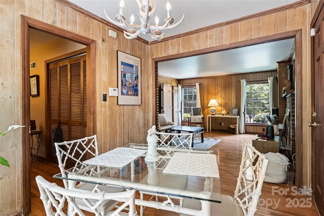 6434 Sardis Rd, Charlotte, NC 28270 - dining room featuring a chandelier, wooden walls, wood finished floors, and crown molding