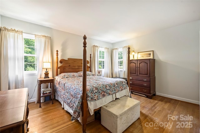 6434 Sardis Rd, Charlotte, NC 28270 - bedroom with light wood-style floors, multiple windows, and baseboards