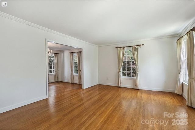 6434 Sardis Rd, Charlotte, NC 28270 - spare room featuring healthy amount of natural light, light wood-type flooring, crown molding, and baseboards