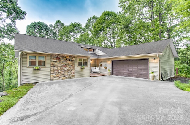 110 Spring Path, Hendersonville, NC 28739 - tri-level home featuring an attached garage, driveway, stone siding, and roof with shingles