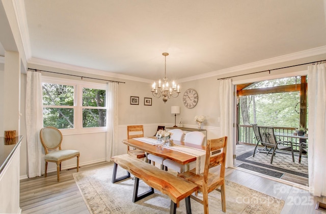 110 Spring Path, Hendersonville, NC 28739 - dining space with a chandelier, crown molding, and light wood-style flooring