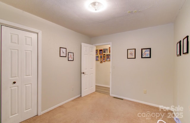 110 Spring Path, Hendersonville, NC 28739 - unfurnished bedroom featuring light colored carpet, a closet, and baseboards