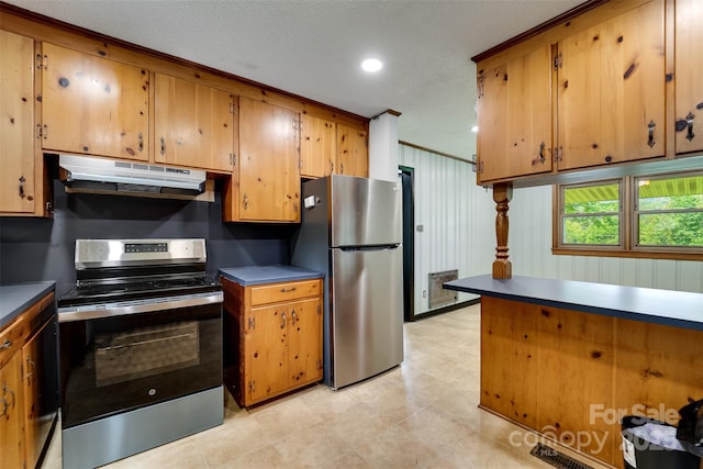 191 Rolling Green Dr, Sylva, NC 28779 - kitchen featuring stainless steel appliances, under cabinet range hood, brown cabinetry, dark countertops, and recessed lighting