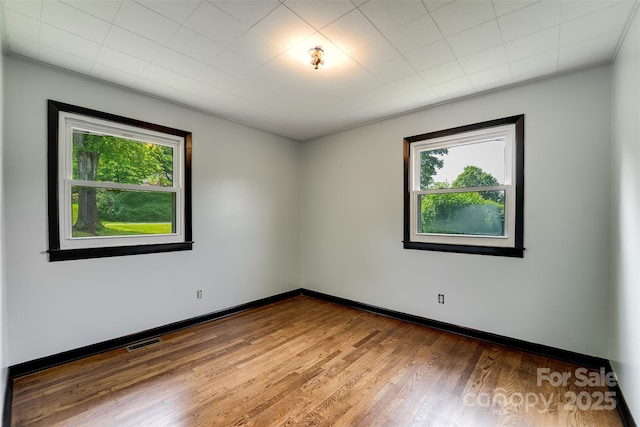 191 Rolling Green Dr, Sylva, NC 28779 - empty room featuring healthy amount of natural light, wood finished floors, crown molding, and baseboards