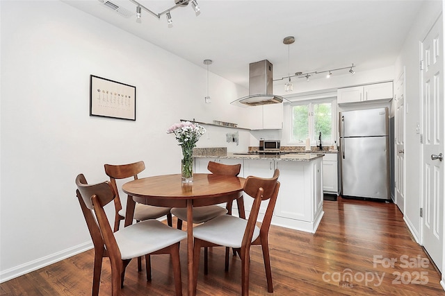 433 W 8th St Unit 66, Charlotte, NC 28202 - dining room featuring rail lighting, dark wood-type flooring, and baseboards