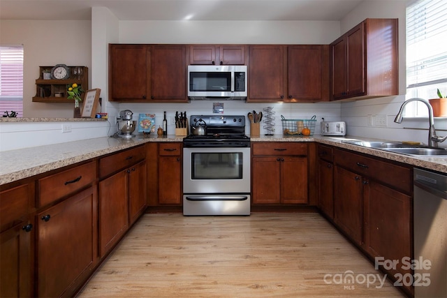 15907 Rose Glenn Ln, Davidson, NC 28036 - kitchen with appliances with stainless steel finishes, a sink, and light wood finished floors