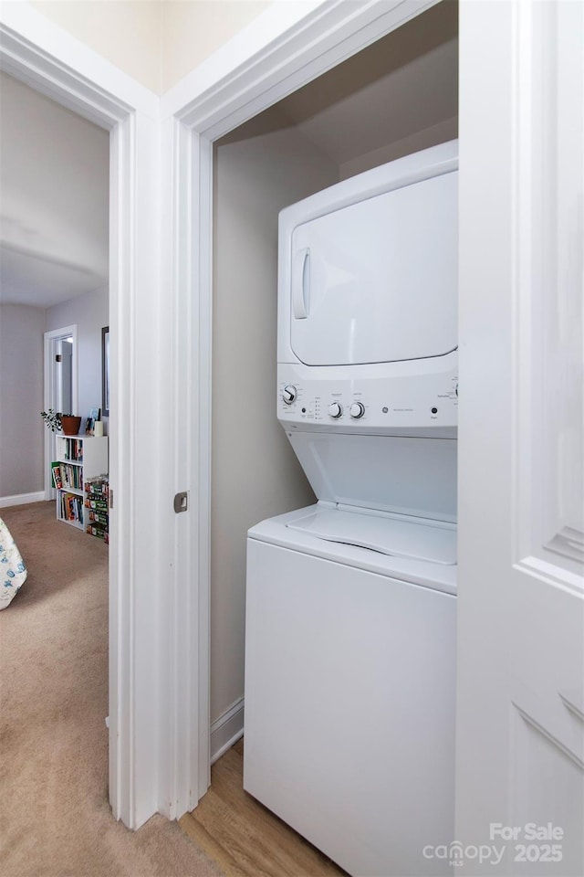 15907 Rose Glenn Ln, Davidson, NC 28036 - washroom with stacked washer / dryer, light carpet, and baseboards