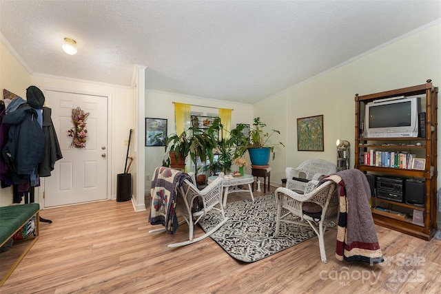 38 Hidden Forest Dr, Hendersonville, NC 28792 - living area with ornamental molding, light wood finished floors, and a textured ceiling
