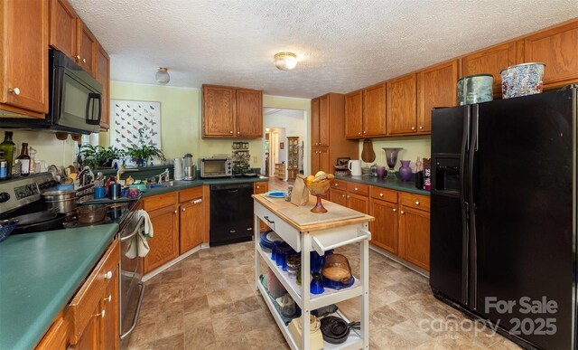 38 Hidden Forest Dr, Hendersonville, NC 28792 - kitchen featuring black appliances, dark countertops, brown cabinets, and a textured ceiling