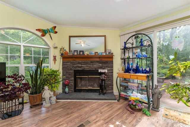 38 Hidden Forest Dr, Hendersonville, NC 28792 - living area with a stone fireplace, wood finished floors, ornamental molding, and ceiling fan